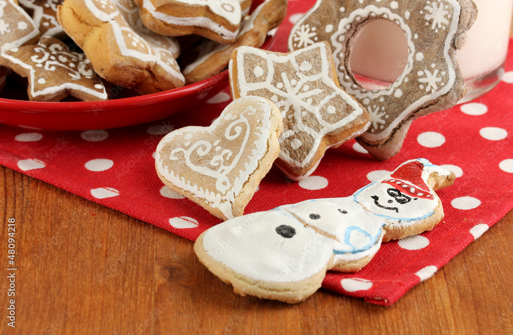 Christmas treats and glass of milk on wooden table close-up Christmas treats and glass of milk on wooden table close-up