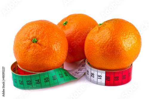 diet concept, tangerine and measure tape isolated on white
