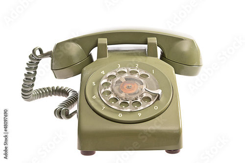 Old fashioned green telephone on white background. photo