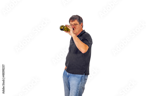 man drinks alcohol out of a bottle © travelview