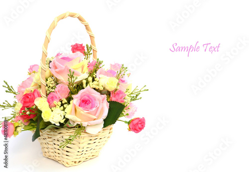 Bouquet of roses in white basket with space for text