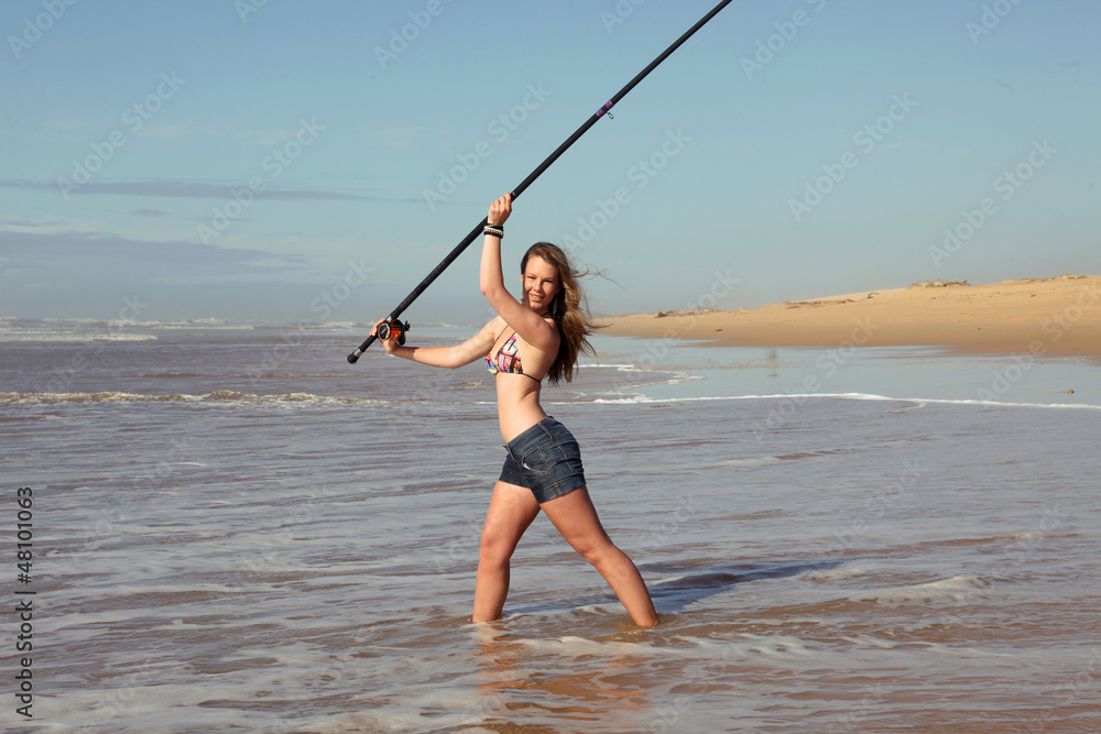 sexy young lady fishing on the beach Photos