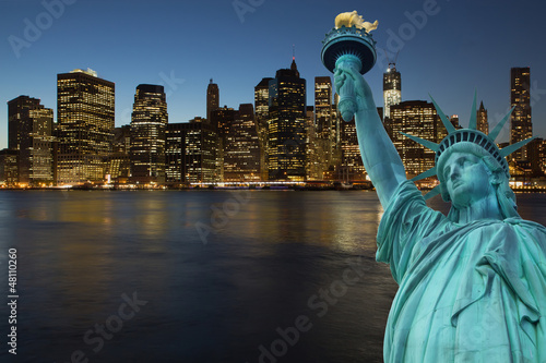 Lower Manhattan at night with Statue of LIberty