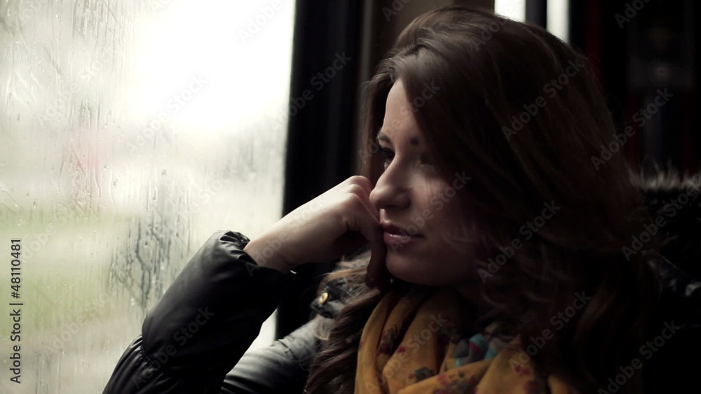 Pensive young woman riding the tram, steadicam shot Pensive young woman riding the tram, steadicam shot