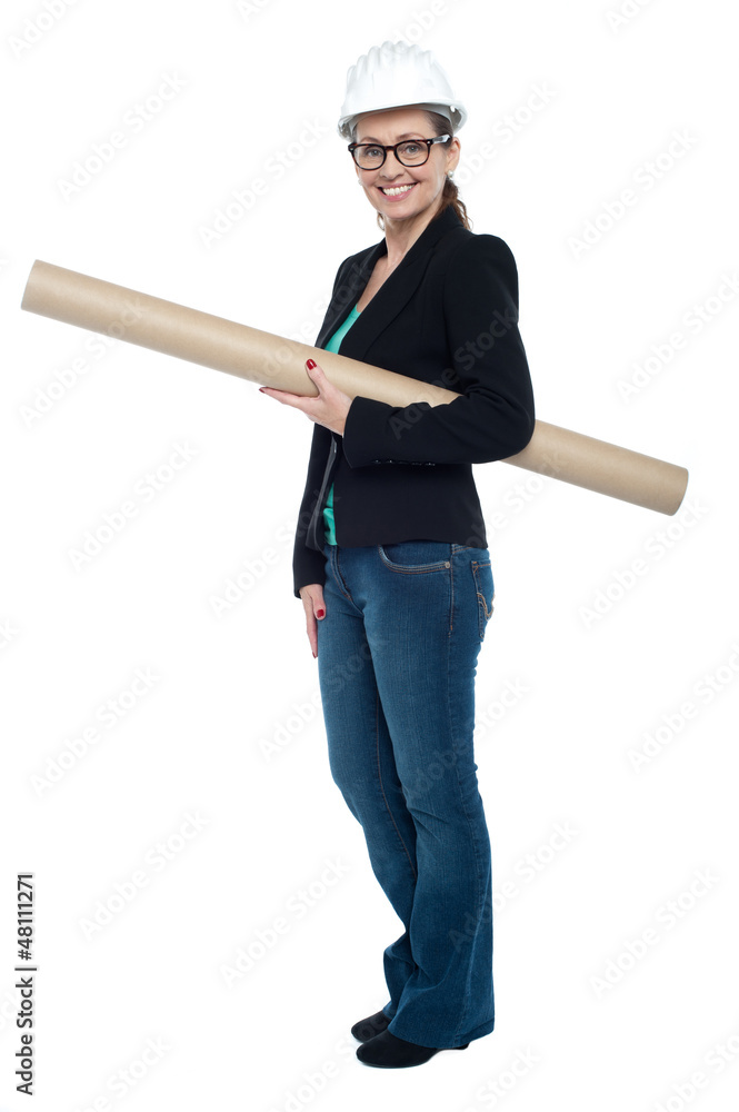 Experienced female architect holding site blueprints Experienced female architect holding site blueprints
