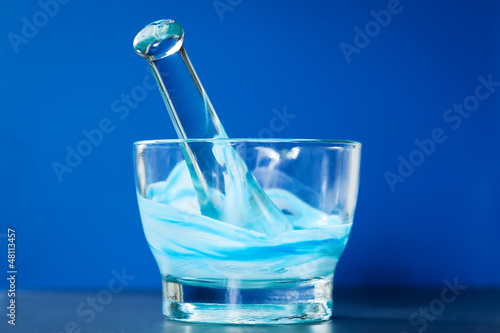 Glass mortar and pestle with blue compound