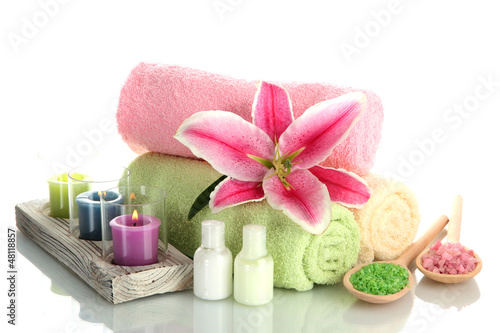 Fototapeta Naklejka Na Ścianę i Meble -  towels with lily, aroma oil,  candles and sea salt isolated