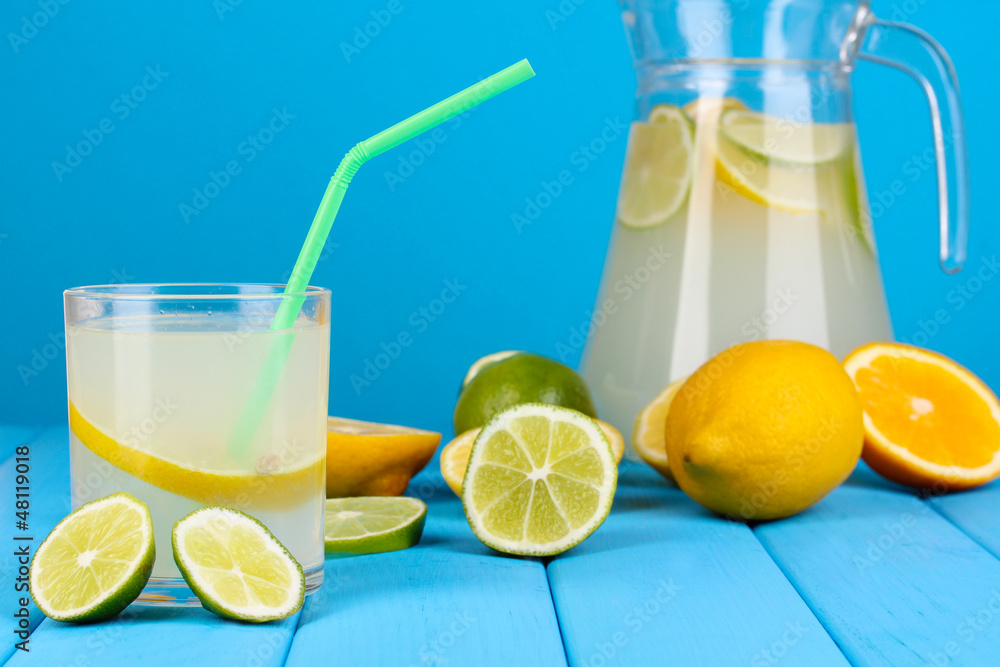 Citrus lemonade in pitcher and glass of citrus around Citrus lemonade in pitcher and glass of citrus around