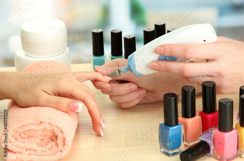 Manicure process in beauty salon  close up