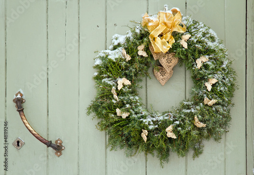 Green Christmas wreath on a wooden door