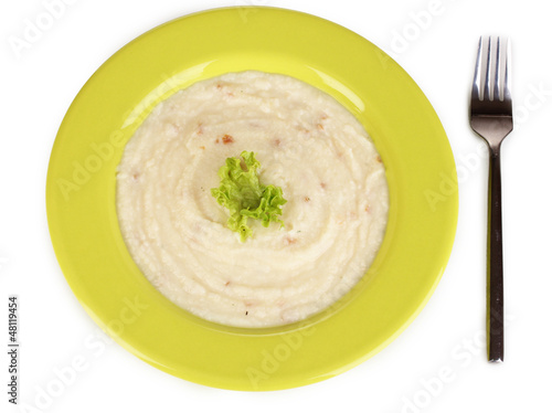Mashed potatoes in green plate isolated on white