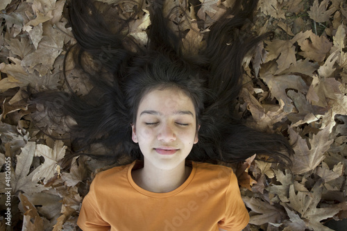 Sleeping girl in the leaves