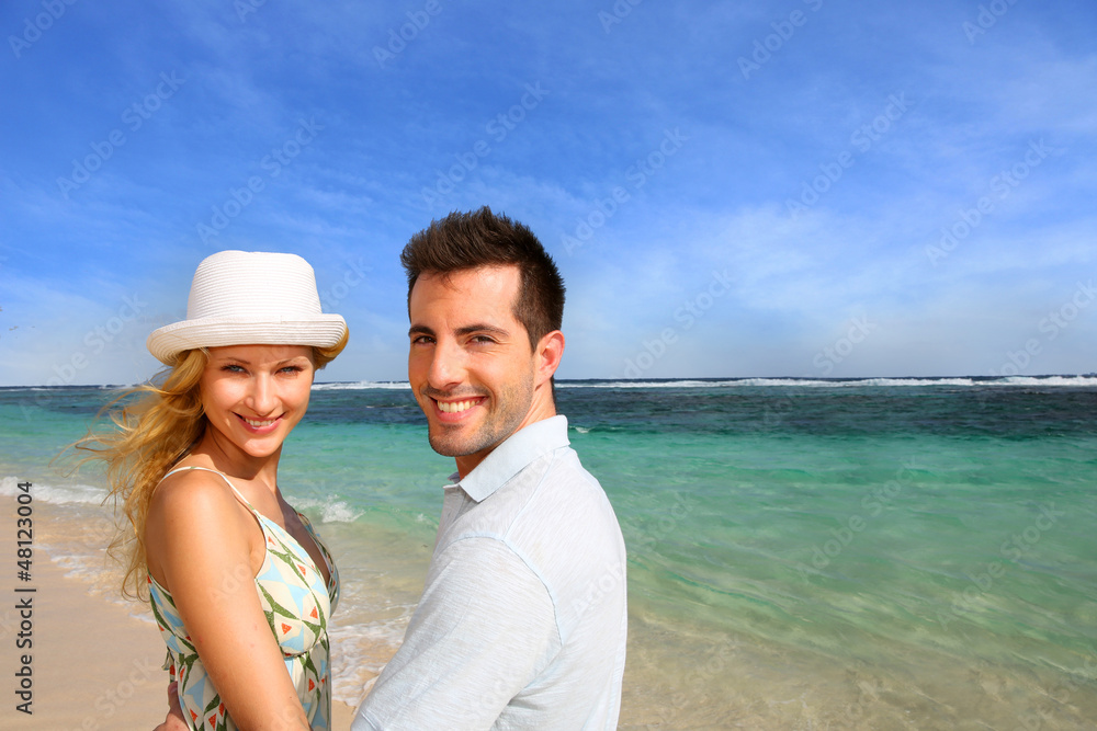 Portrait of cheerful couple at the beach
