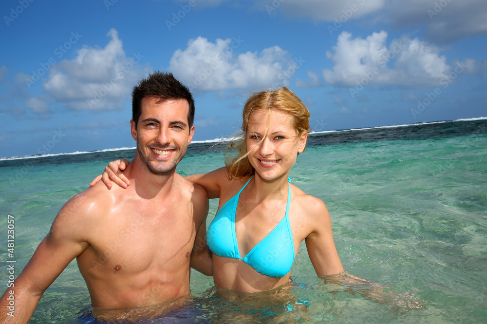 Cheerful couple swimming in a caribbean lagoon Cheerful couple swimming in a caribbean lagoon