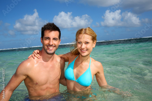 Cheerful couple swimming in a caribbean lagoon © goodluz