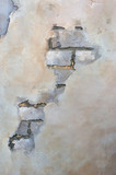 Brick wall with peeling plaster