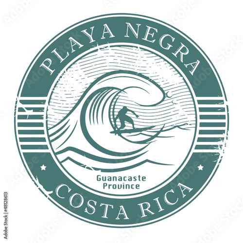 Stamp with surfer on wave and name of Playa Negra, Costa Rica