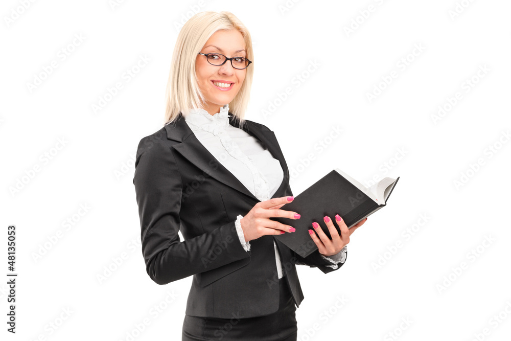 A blond female teacher holding a book A blond female teacher holding a book