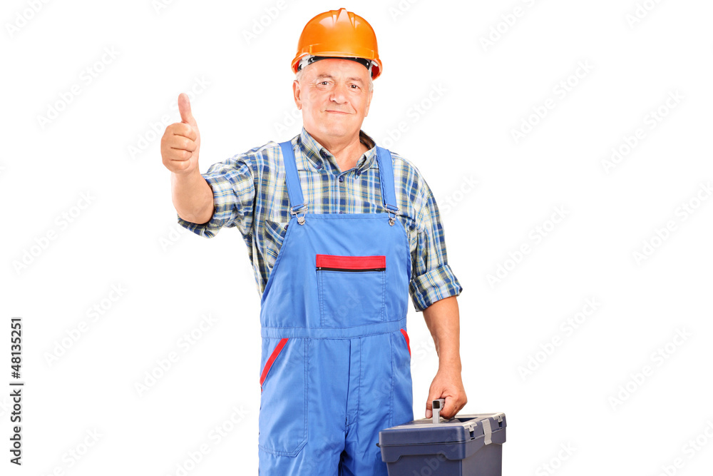 A manual worker holding tool box and giving a thumb up A manual worker holding tool box and giving a thumb up