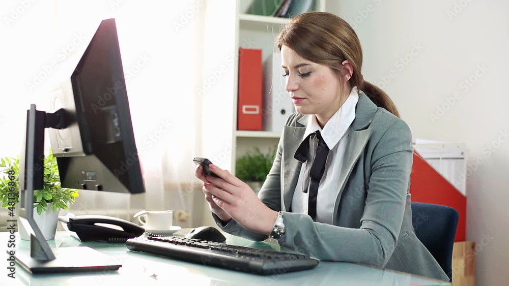 Young businesswoman using smartphone in the office Young businesswoman using smartphone in the office