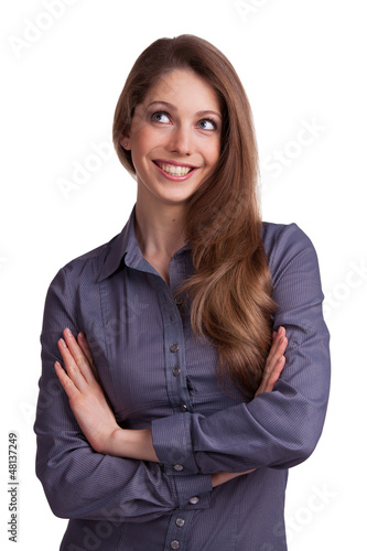 Young woman with long hair smiles coyly photo