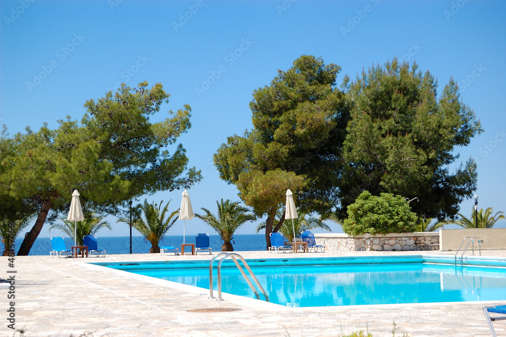 Swimming pool by a beach at the luxury hotel, Halkidiki, Greece Swimming pool by a beach at the luxury hotel, Halkidiki, Greece