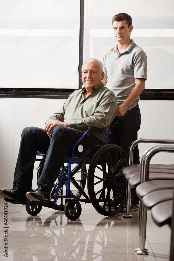 Man With Grandfather Sitting In Wheelchair Man With Grandfather Sitting In Wheelchair