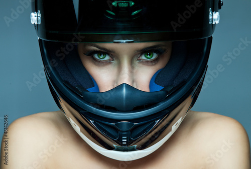 Sexy woman in helmet on blue background photo