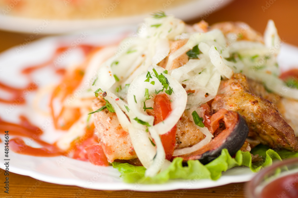 Appetizing weal kebab on skewers with greens Appetizing weal kebab on skewers with greens