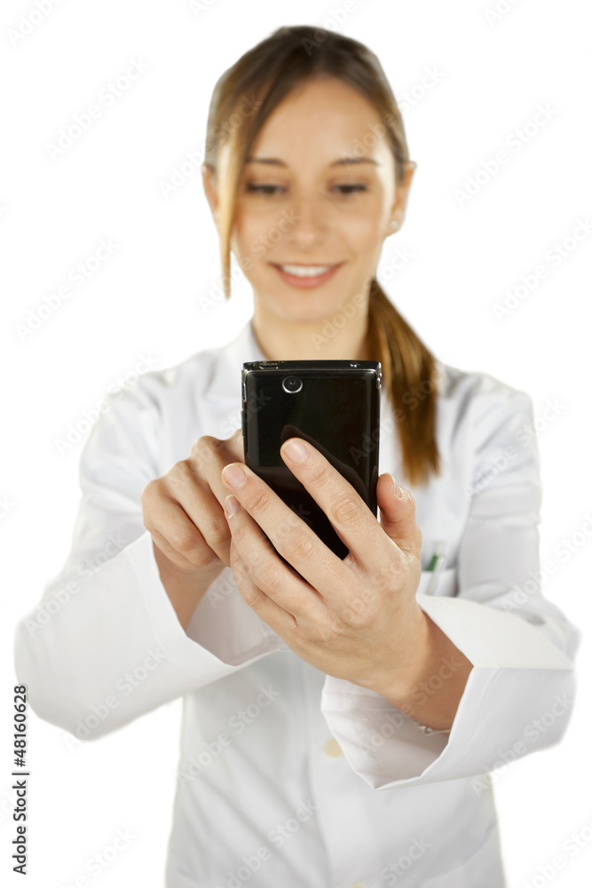Portrait of a young smiling doctor using smartphone Portrait of a young smiling doctor using smartphone