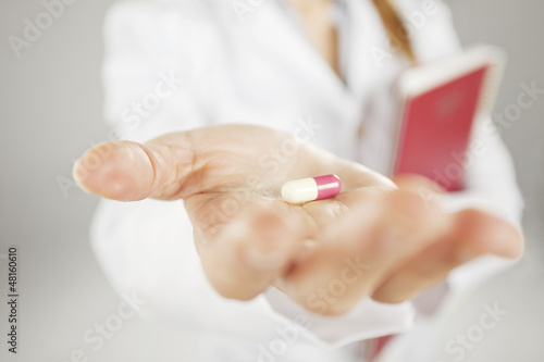 medical woman with pill in the hand