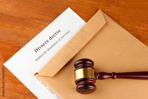 Divorce decree and envelope on wooden background