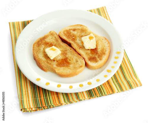 White bread toastwith honey on plate, isolated on white photo