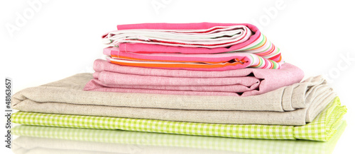 Pile of different fabrics isolated on white