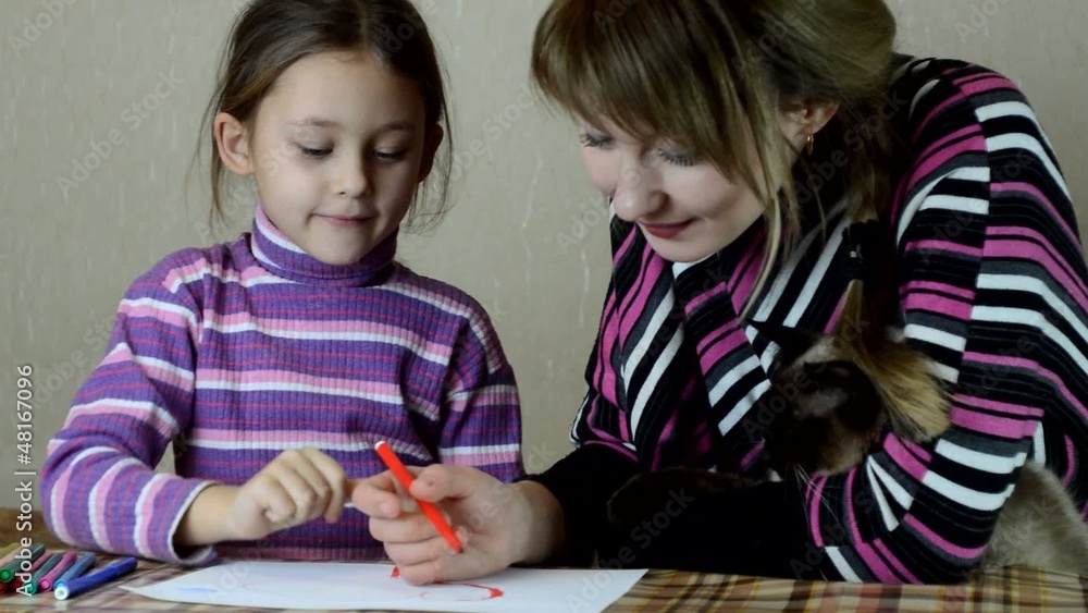 mother and daughter paint pens on white paper