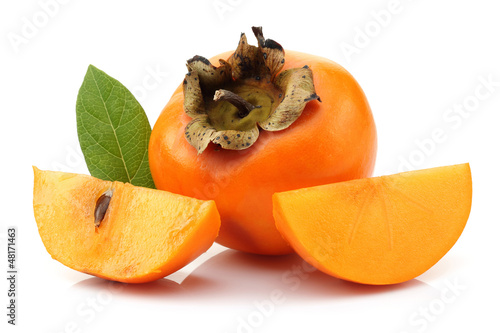 Slice persimmons with green leaves