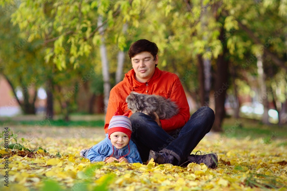 Family with cat in the autumn park