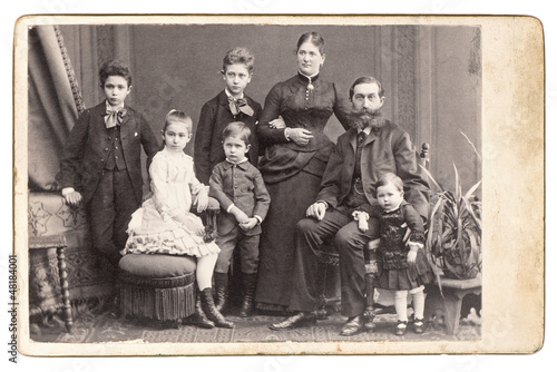 old family photo. parents with five children