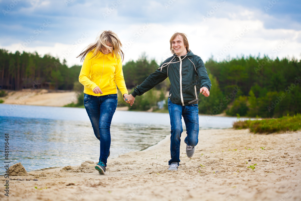 couple are walking on the beach