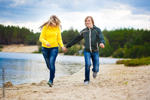 couple are walking on the beach © Dmytro Titov