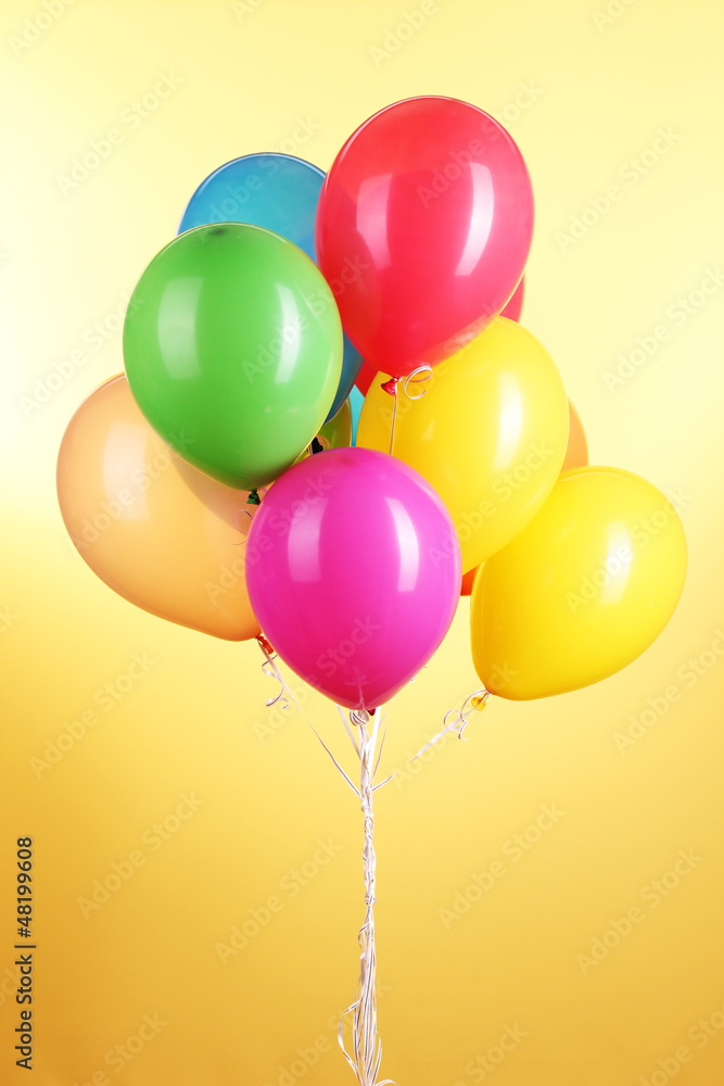 Colorful balloons on yellow background Colorful balloons on yellow background