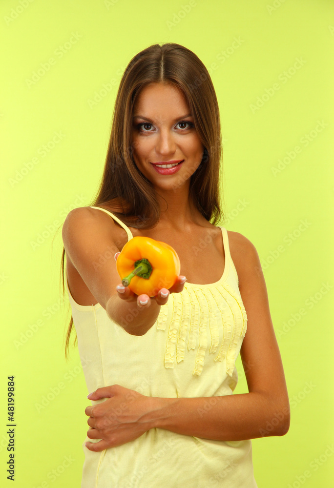 beautiful young woman with paprika, on green background beautiful young woman with paprika, on green background