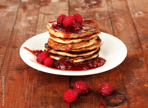 delicious sweet pancakes on wooden background