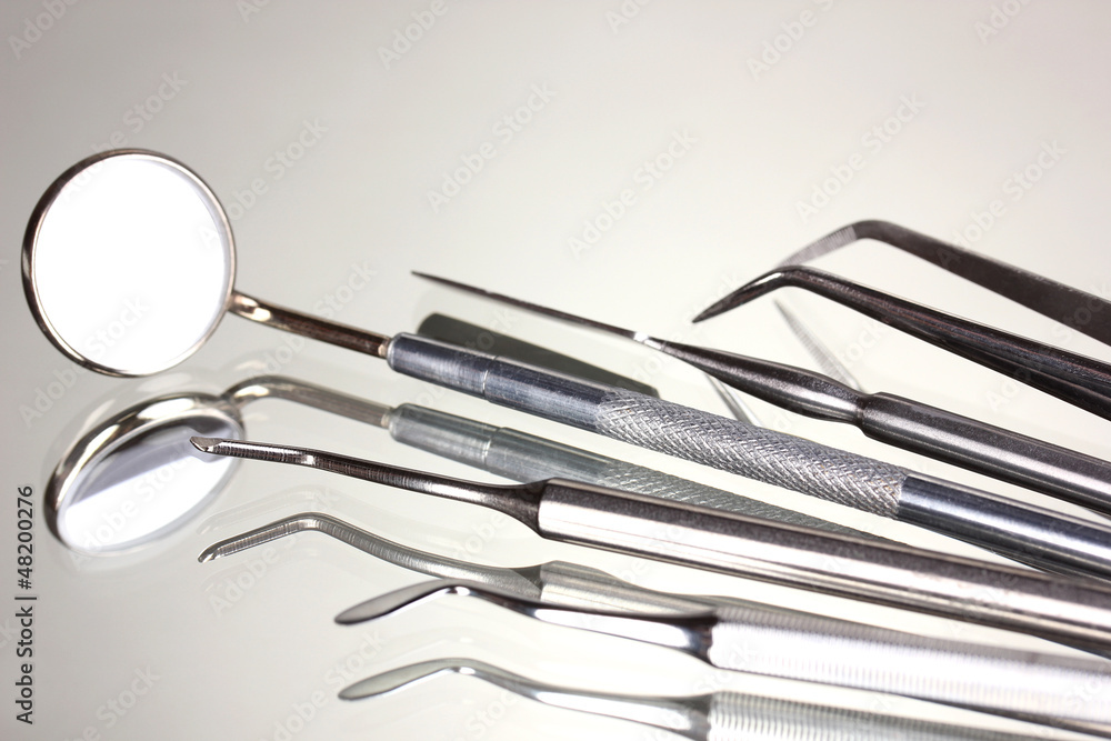 Set of dental tools for teeth care isolated on grey background Set of dental tools for teeth care isolated on grey background