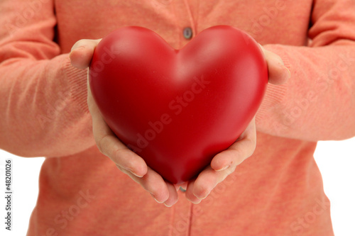Fototapeta Naklejka Na Ścianę i Meble -  Red heart in woman hands, close up