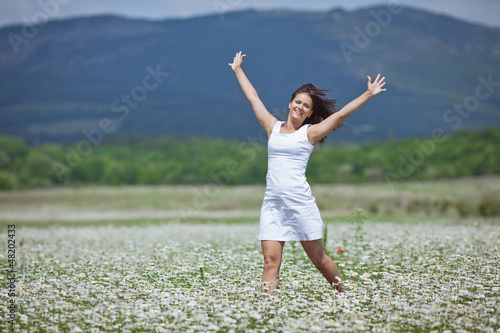 Girl in chamomile field