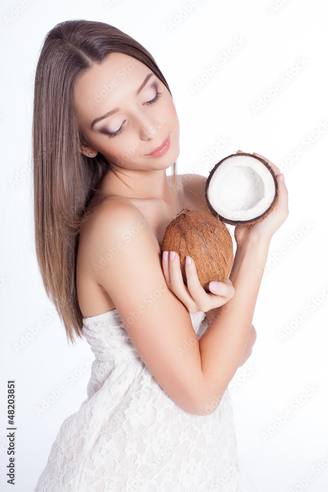 woman with perfect skin holding coconut over white background woman with perfect skin holding coconut over white background