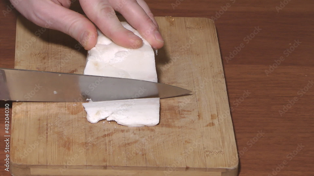 Pork fat cutting by a knife. Pork fat cutting by a knife.