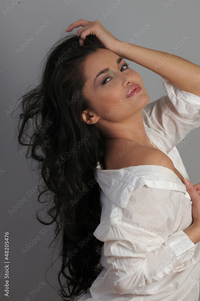 Naklejka premium Portrait of sexy Asian brunette at grey background