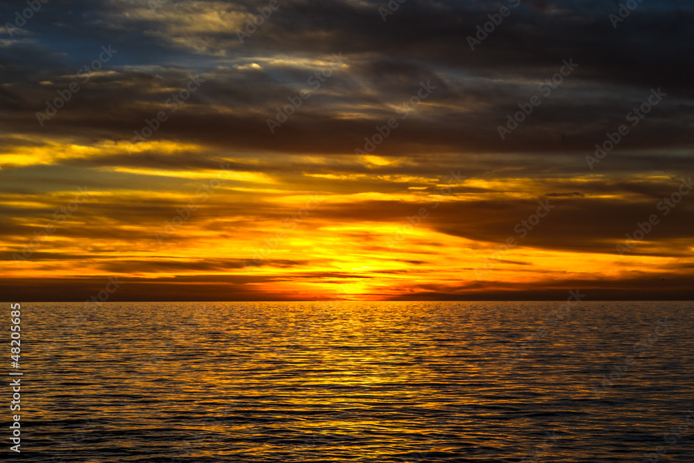 dramatic golden sunset over the ocean